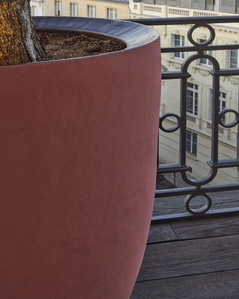 Coin repas extérieur sur un balcon parisien végétalisé et lumineux
